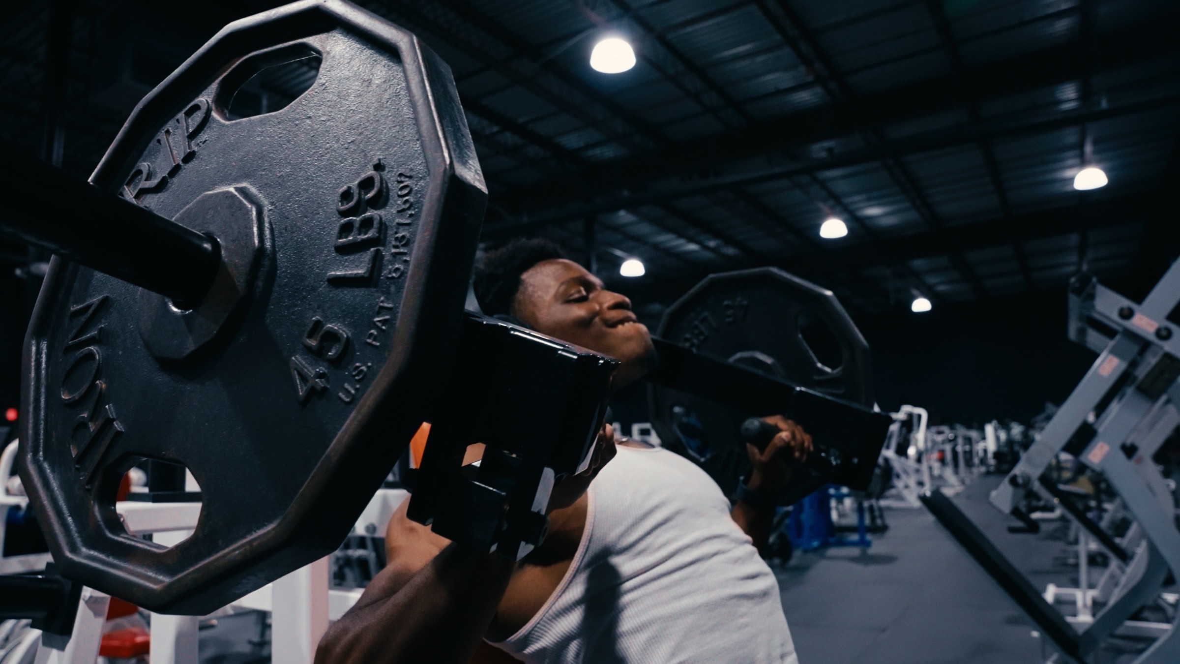 Pressing a loaded barbell in the gym